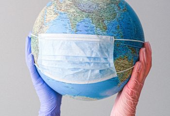 Canva - Hands With Latex Gloves Holding a Globe with a Face Mask