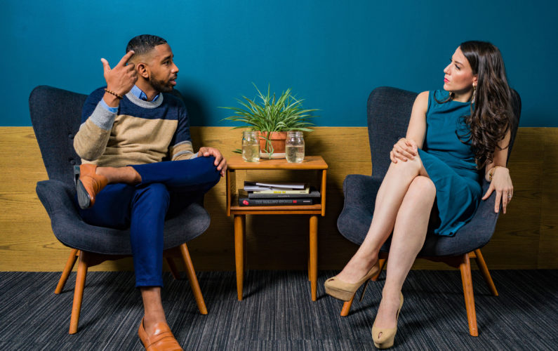 Canva - Woman Wearing Teal Dress Sitting on Chair Talking to Man