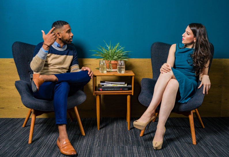 Canva - Woman Wearing Teal Dress Sitting on Chair Talking to Man